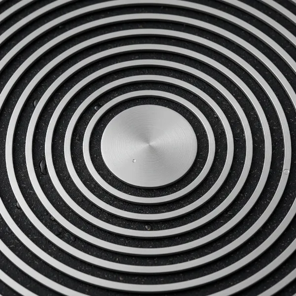 A close-up view of Circulon SteelShield pan surface showing elevated stainless steel rings protecting non-stick grooves, highlighting hybrid technology.